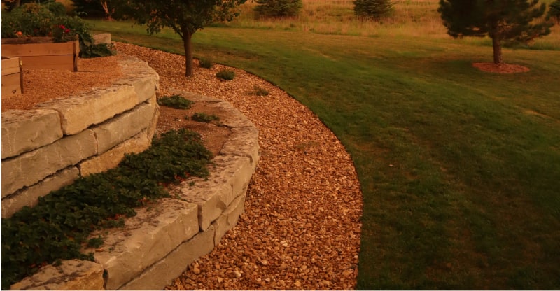 Rock bed with freshly laid stone edging at sunset.